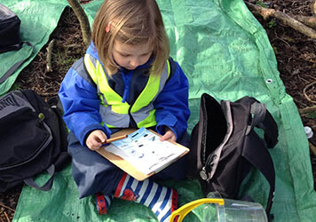 Exploring the forest with  at Lilliputs Day Nursery in Westhoughton