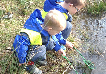 Exploring the forest with  at Lilliputs Day Nursery in Westhoughton